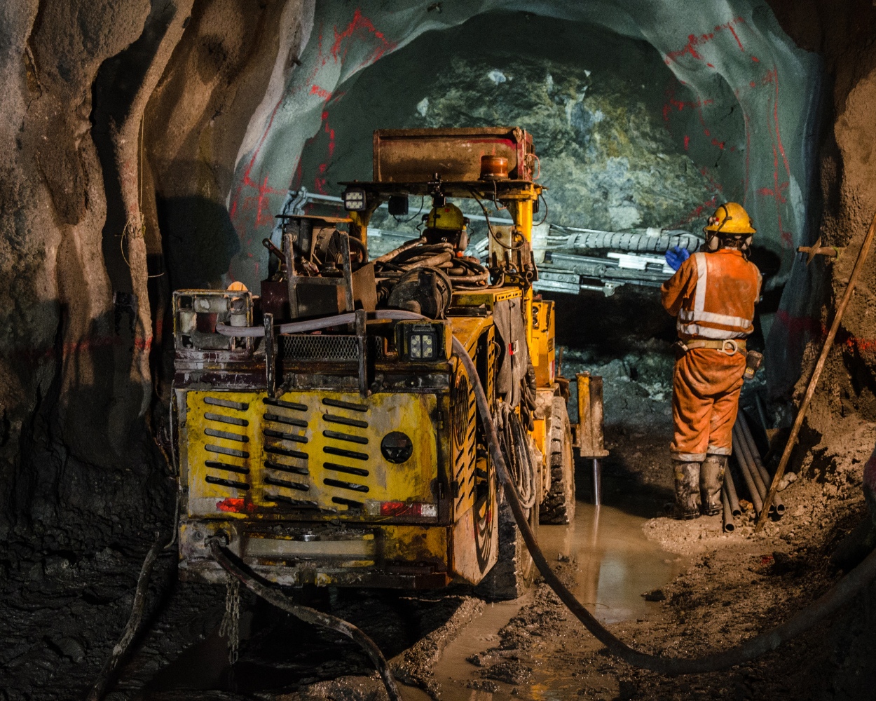 Mining crew operating underground drilling equipment
