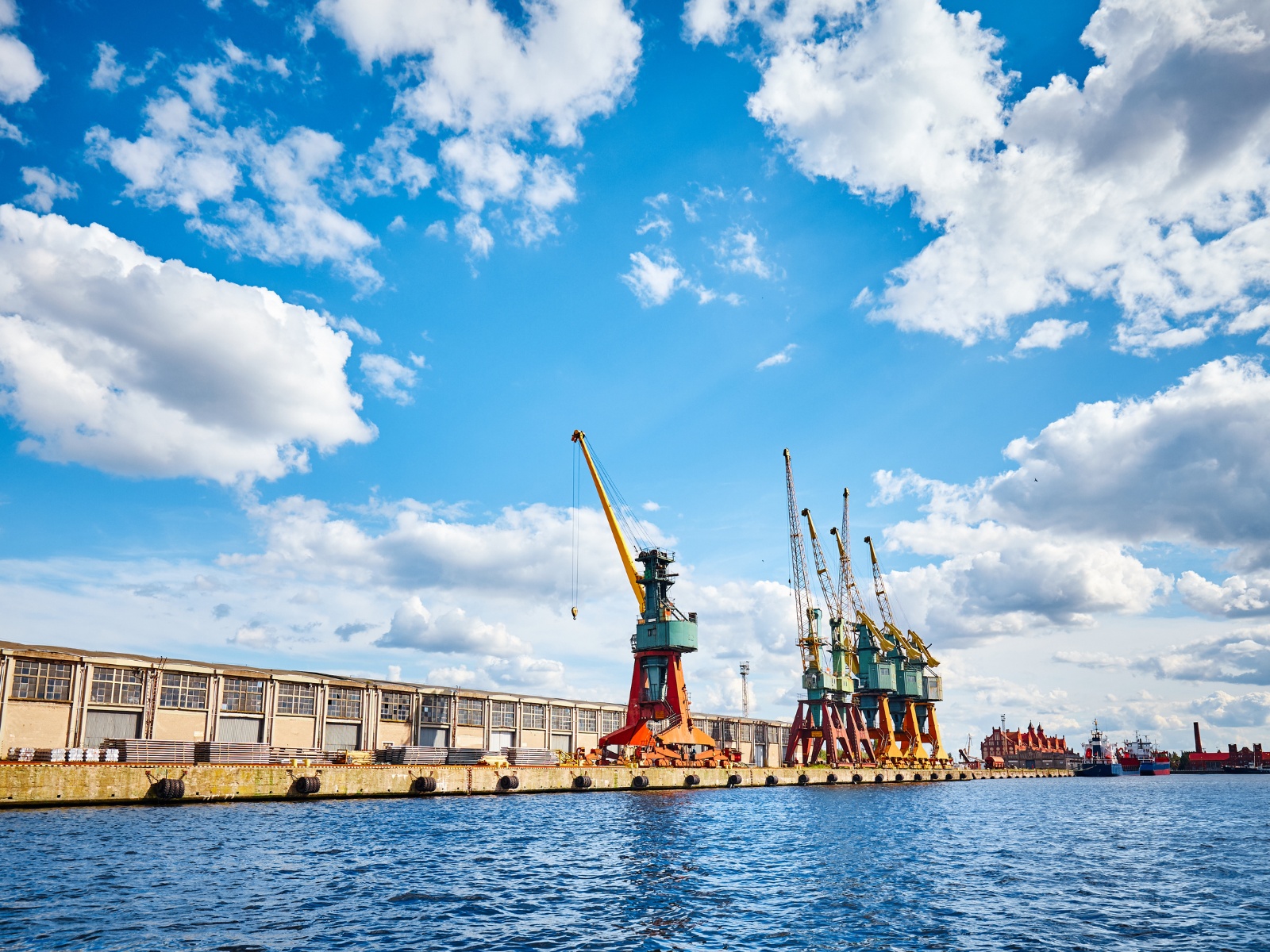 Port cranes loading a container ship
