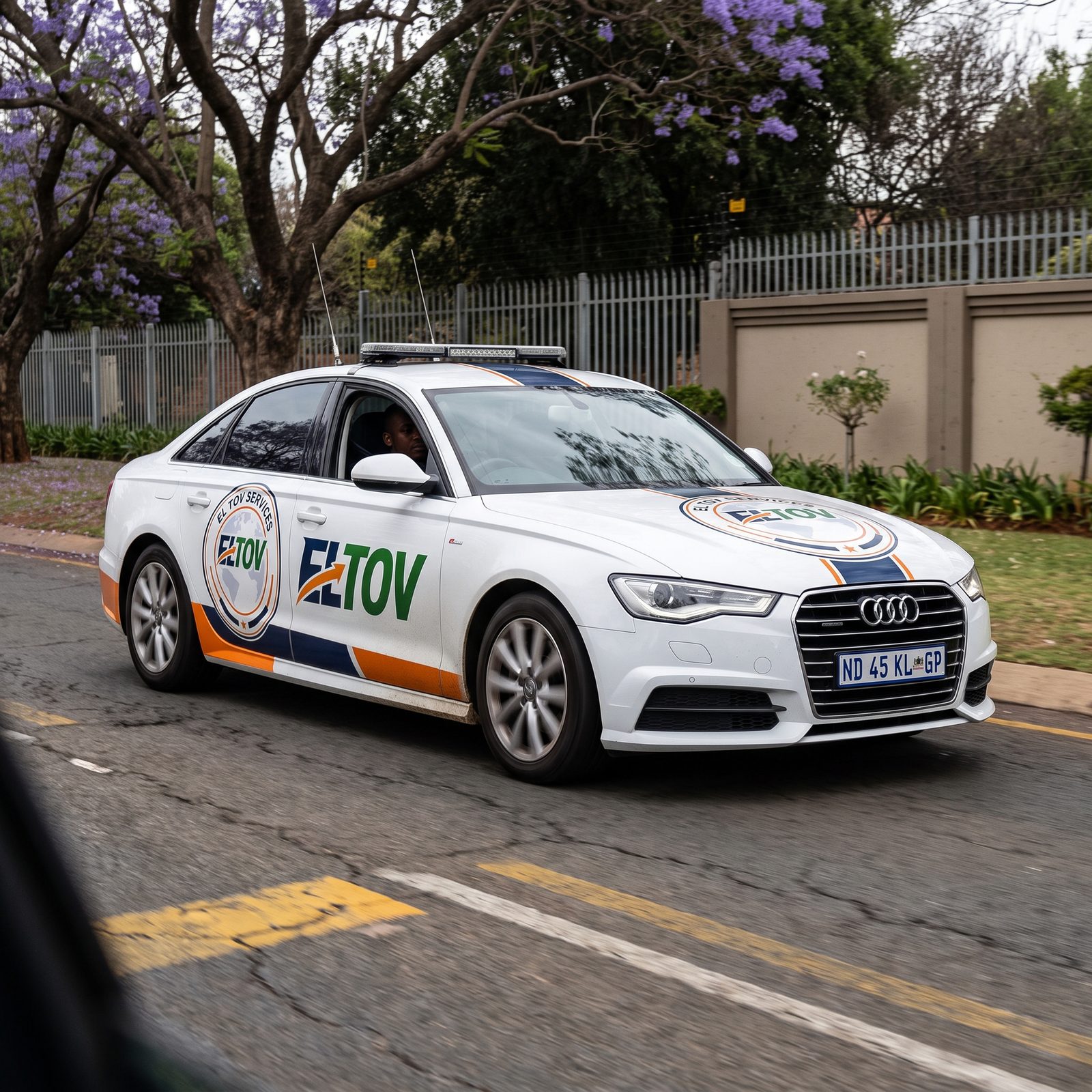 Eltov Security branded patrol vehicle responding on a tree-lined street